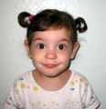 Cupcake Master, approximately age 3, wearing tiny pigtails.